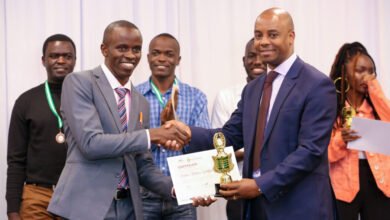 Safaricom Chief Corporate Affairs Officer, Stephen Chege presents a trophy and certificate to Stephen Muchiri Waithanji, a recent JKUAT graduate who emerged the winner during the My Little Big Thing Innovation Challenge