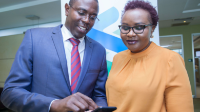 Standard Chartered Head of Wealth Management Kenya and East Africa Paul Njoki (left), takes the bank's Head of Retail Banking Kenya Edith Chumba through the T bills and Bonds trading process during the launch