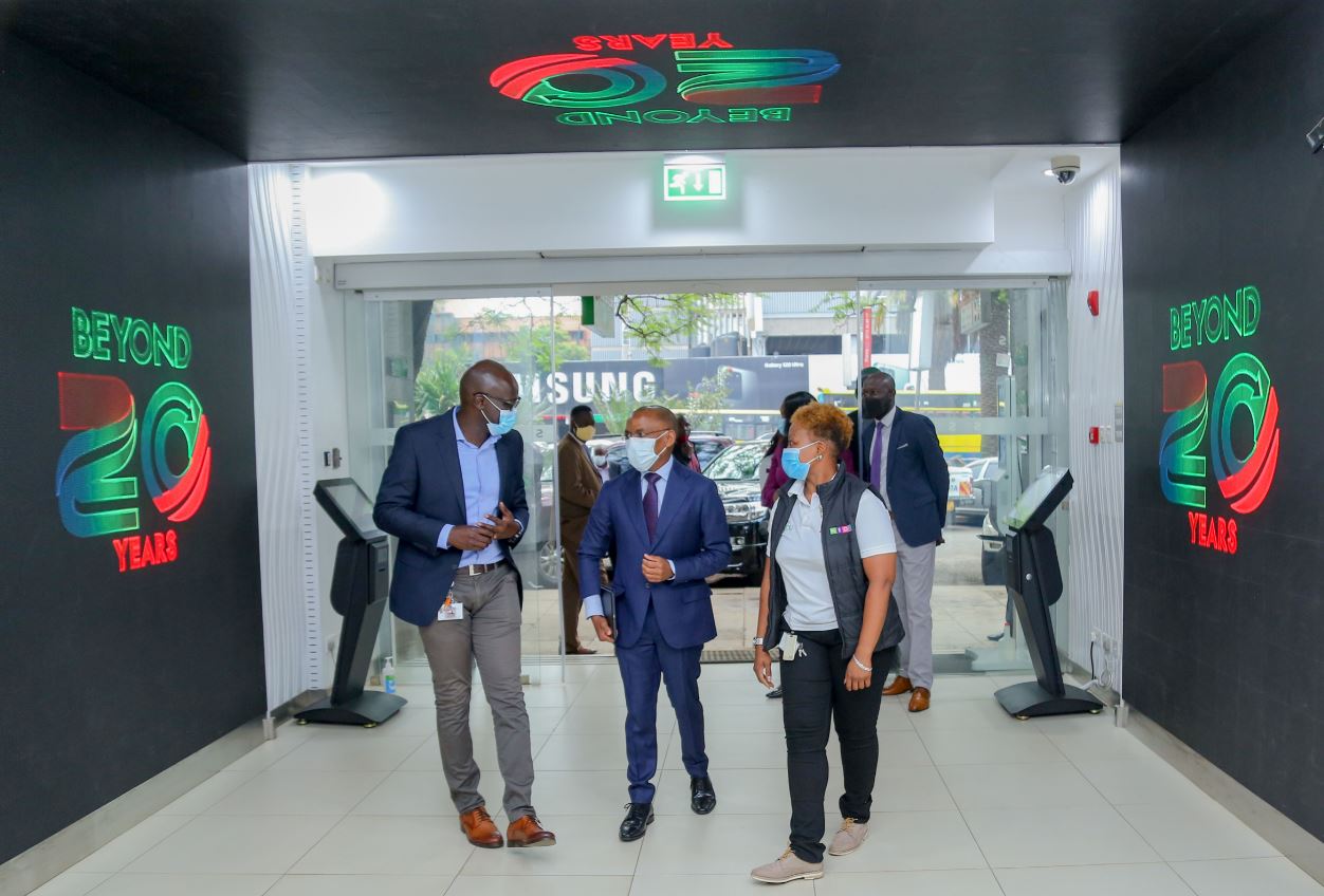 Safaricom HOD Retail Strategy, Franchise and Mobile Care Yudah Yogo, Safaricom Chief Executive Officer Peter Ndegwa, being taken around the newly refurbished shop with Sarah Indetie-Senior Manager Retail Asset Management during the launch of the heavy tech store in Moi avenue. This first-of-a-kind digitized flagship shop has a video tunnel at the entrance, digital interactive screens and device display screens for a wide variety of phones and accessories on sale.