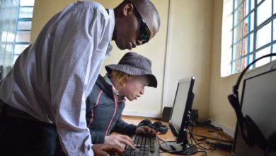 Anthony Wambua, Computer Instructor, inABLE giving instructions to Wycliffe Ochieng', Boot camp trainee on how to MS Excel through assistive technology during the Entrepreneurship Bootcamp for 40 blind and visually impaired youths in Kenya hosted by inABLE and the US Embassy in Kenya, at Thika Primary School for the Blind in Kiambu County.