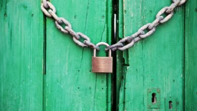 brass colored metal padlock with chain