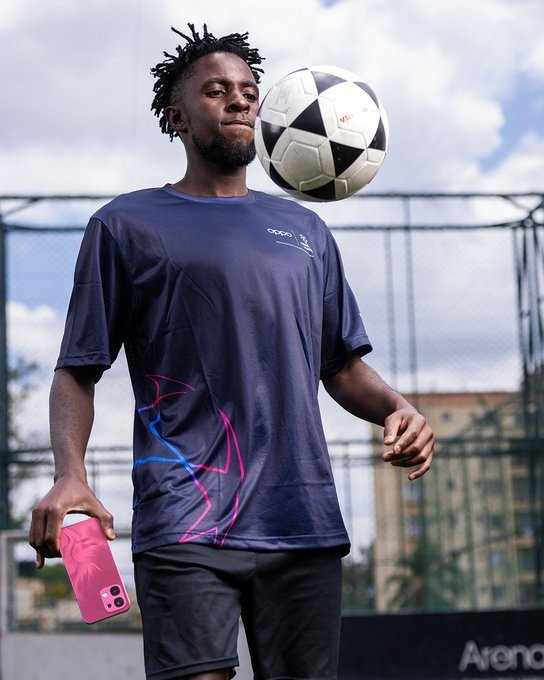 Austine-Odhiambo-holding-OPPO-A6-Pro-while-chesting-the-ball