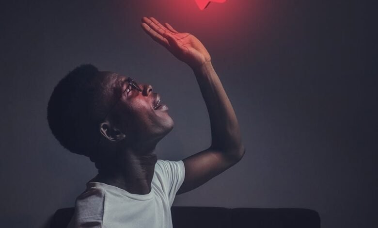 Kenya Wants to Regulate Influencers Like China. Here's Why That's a Terrible Idea. man in white crew neck top reaching for the like