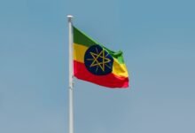 Ethiopia liberalises forex: Service exporters now retain 100% earnings, whilst investors enjoy frictionless profit repatriation, unlocking the nation's digital economy. flag of ethopia under blue sky