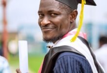 smiling graduate with diploma in hand