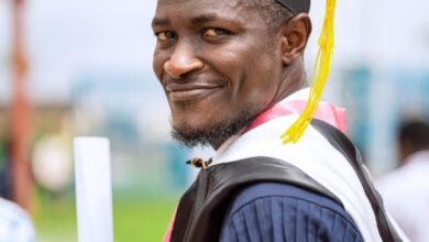 smiling graduate with diploma in hand