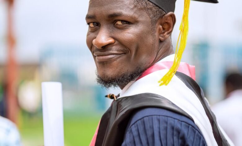 smiling graduate with diploma in hand
