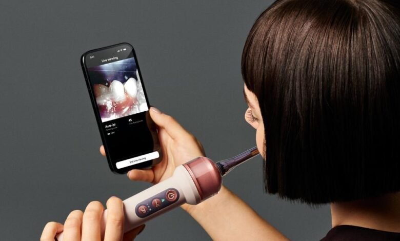Dyson's CameraJet toothbrush has a 0.1-megapixel camera that finds gaps between teeth and jets mouthrinse into them for USD 499.